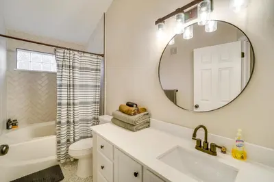 a white bathroom with a sink and a mirror at 16 Mi to DIA Townhome with Fireplace in Aurora in Aurora