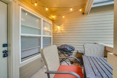 a porch with two chairs and a table and a window at 16 Mi to DIA Townhome with Fireplace in Aurora in Aurora