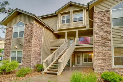 a house with an american flag on it at 16 Mi to DIA Townhome with Fireplace in Aurora in Aurora
