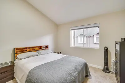 a white bedroom with a bed and a window at 16 Mi to DIA Townhome with Fireplace in Aurora in Aurora