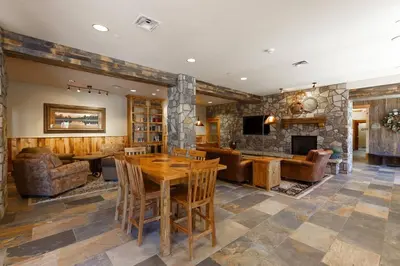 a living room with a table and a fireplace at 8045 Black Bear condo in Keystone