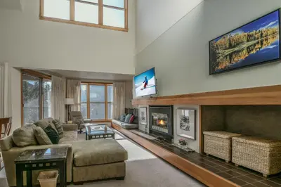 a living room with a couch and a fireplace at Quicksilver 1677 by SummitCove Lodging in Keystone