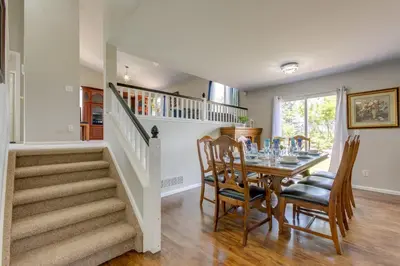 a dining room with a table and a stairway at Spacious Aurora Home 20 Mi to Downtown Denver! in Aurora