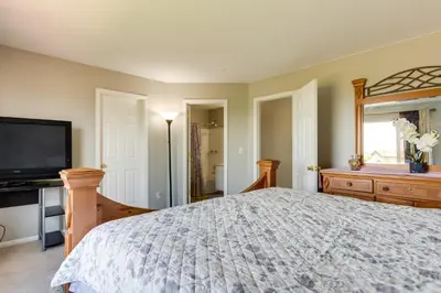 a bedroom with a bed and a flat screen tv at Spacious Aurora Home 20 Mi to Downtown Denver! in Aurora