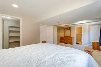 a bedroom with a large white bed and a closet at Spacious Aurora Home 20 Mi to Downtown Denver! in Aurora