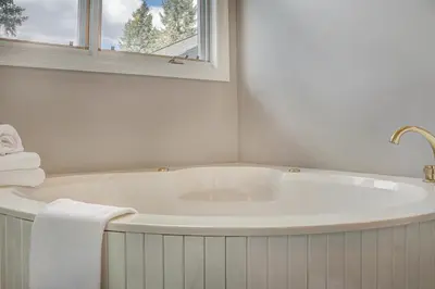a white bath tub in a bathroom with a window at 5 Ski Resorts within 16 Miles - Salt Water Hot Tub in Dillon