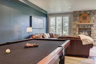 a living room with a pool table and a couch at 5 Ski Resorts within 16 Miles - Salt Water Hot Tub in Dillon