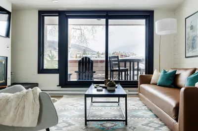 a living room with a couch and a table at Keystone Lake - MTN View - Pool Hot Tub Gym Sauna in Dillon