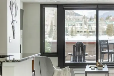 a living room with two chairs and a table at Keystone Lake - MTN View - Pool Hot Tub Gym Sauna in Dillon