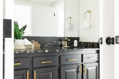 a bathroom with black cabinets and a sink at Keystone Lake - MTN View - Pool Hot Tub Gym Sauna in Dillon