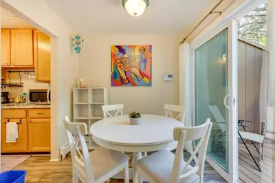 a dining room with a white table and chairs at Beautiful Boulder Townhome Walk to CU and Pearl St! in Boulder