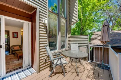 a patio with a table and chairs on a porch at Beautiful Boulder Townhome Walk to CU and Pearl St! in Boulder