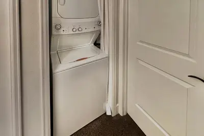 a white refrigerator with its door open next to a door at Mountain Vista Retreat in Winter Park