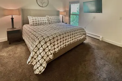 a bedroom with a bed with a comforter and a window at Mountain Vista Retreat in Winter Park