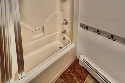 a bathroom with a tub and a shower stall at Mountain Vista Retreat in Winter Park