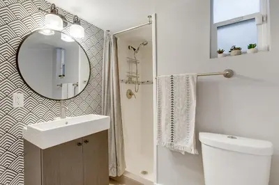 a bathroom with a sink and a mirror at Updated Denver Home about 3 Mi to Downtown! in Denver