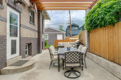 a patio with a table and chairs and a fence at Updated Denver Home about 3 Mi to Downtown! in Denver