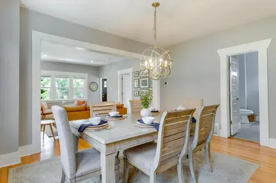 a dining room and living room with a table and chairs at Updated Denver Home about 3 Mi to Downtown! in Denver