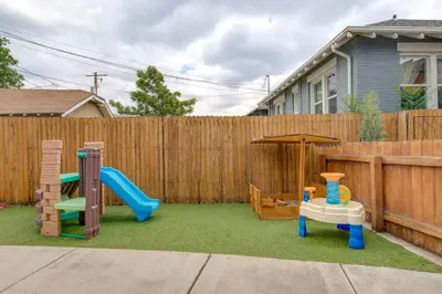 a backyard with a playground with a slide and an umbrella at Updated Denver Home about 3 Mi to Downtown! in Denver