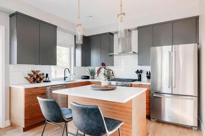a kitchen with a white counter and a refrigerator at Luxe Getaway - Yard & Roof Deck - 4 Story Townhome in Denver