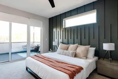a bedroom with a large bed and a large window at Luxe Getaway - Yard & Roof Deck - 4 Story Townhome in Denver