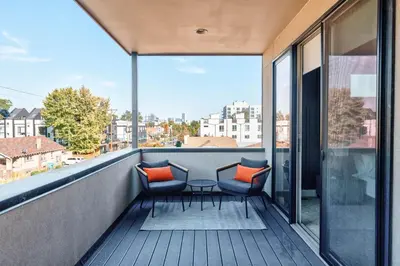a balcony with two chairs and a table on it at Luxe Getaway - Yard & Roof Deck - 4 Story Townhome in Denver