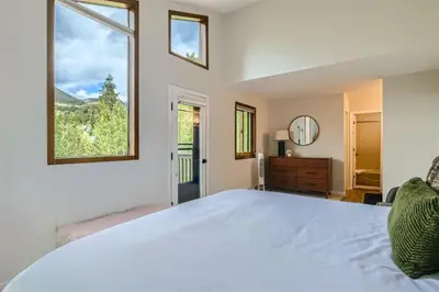 a bedroom with a large bed with a large window at Hawn Drive 62 townhouse in Frisco