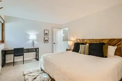 a bedroom with a large bed and a desk at Hawn Drive 62 townhouse in Frisco