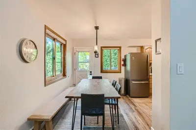 a dining room with a table and a refrigerator at Hawn Drive 62 townhouse in Frisco