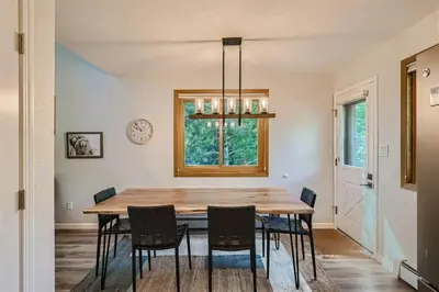 a dining room with a wooden table and chairs at Hawn Drive 62 townhouse in Frisco