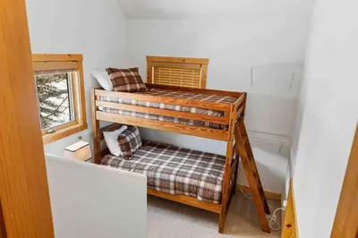 two bunk beds in a small room with a window at Waterdance House home in Frisco