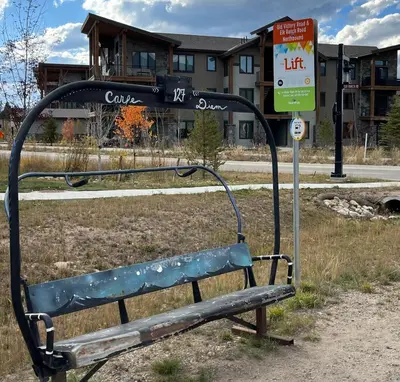 a park bench in front of a bus stop at Brand New! Private hot tub, bunk room and walkable to restaurants/shops in Fraser