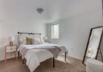 a white bedroom with a bed and a mirror at Denver Hot Tub Retreat Near Downtown - 20 Percent Off Feb in Westminster