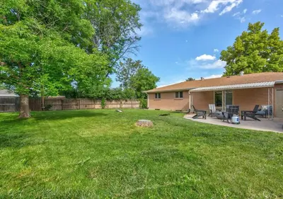 a yard with a house and a fence at Denver Hot Tub Retreat Near Downtown - 20 Percent Off Feb in Westminster