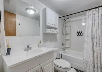 a white bathroom with a sink and a toilet at Denver Hot Tub Retreat Near Downtown - 20 Percent Off Feb in Westminster