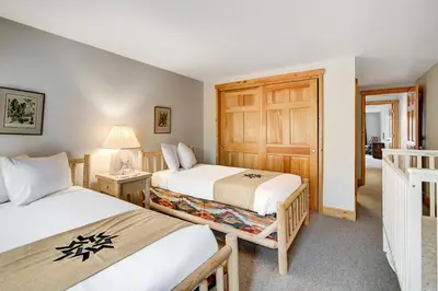 a bedroom with two beds and a door at Beautiful 5br Home at The Ranch - Kids Ski Free! condo in Keystone