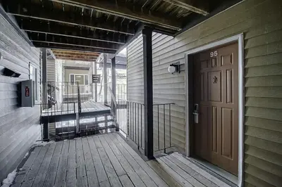 a wooden porch with a door on a house at New Listing - Slopeside condo with Private Hot Tub in Granby