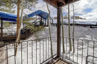 a balcony with snow on the ground and a train station at New Listing - Slopeside condo with Private Hot Tub in Granby