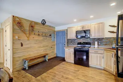 a kitchen with wooden cabinets and a stove top oven at New Listing - Slopeside condo with Private Hot Tub in Granby