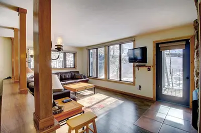a living room with a couch and a tv at New Listing - Slopeside condo with Private Hot Tub in Granby