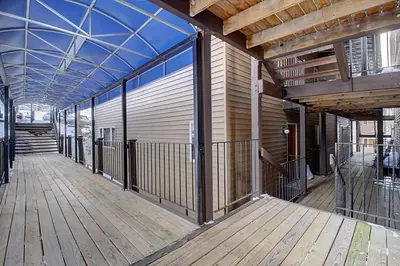 a room with a wooden floor and a building at New Listing - Slopeside condo with Private Hot Tub in Granby