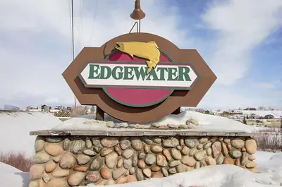 a sign for the edgewater on top of a rock wall at Modern 3bd cabin in Edgewater in Granby
