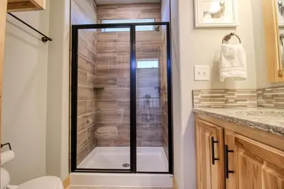 a bathroom with a shower with a glass door at Modern 3bd cabin in Edgewater in Granby