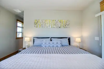 a large bed in a bedroom with two lamps at Modern 3bd cabin in Edgewater in Granby