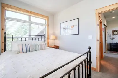 a bedroom with a bed and a window at Modern 3bd cabin in Edgewater in Granby