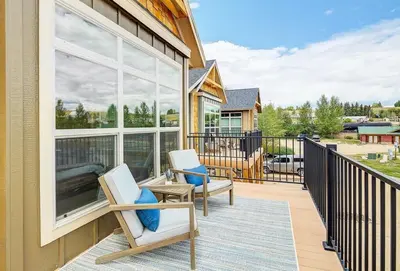 a porch with two chairs and a large window at Cozy 3 bedroom Mountain Getaway - Ski Fish Golf in Granby