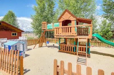 a playground with a tree house and a slide at Cozy 3 bedroom Mountain Getaway - Ski Fish Golf in Granby