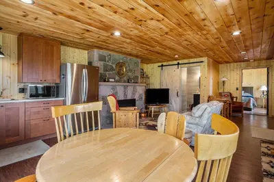 a kitchen and living room with a wooden ceiling at Frontier Mountain Retreat - Monthly Long-Term Vacation Rental 30 Days Minimum -- Estes Park apts in Estes Park