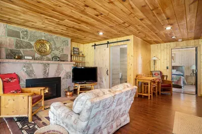 a living room with a couch and a fireplace at Frontier Mountain Retreat - Monthly Long-Term Vacation Rental 30 Days Minimum -- Estes Park apts in Estes Park
