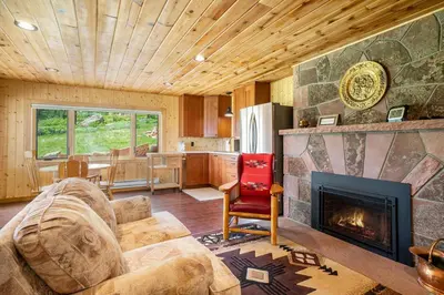 a living room with a couch and a fireplace at Frontier Mountain Retreat - Monthly Long-Term Vacation Rental 30 Days Minimum -- Estes Park apts in Estes Park